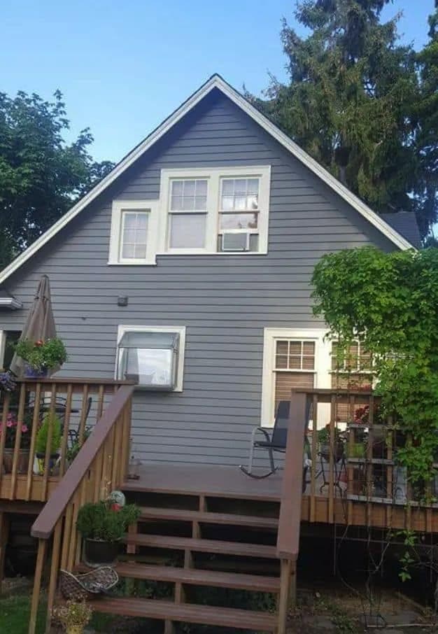 The same gable end finished in slate grey with white trim