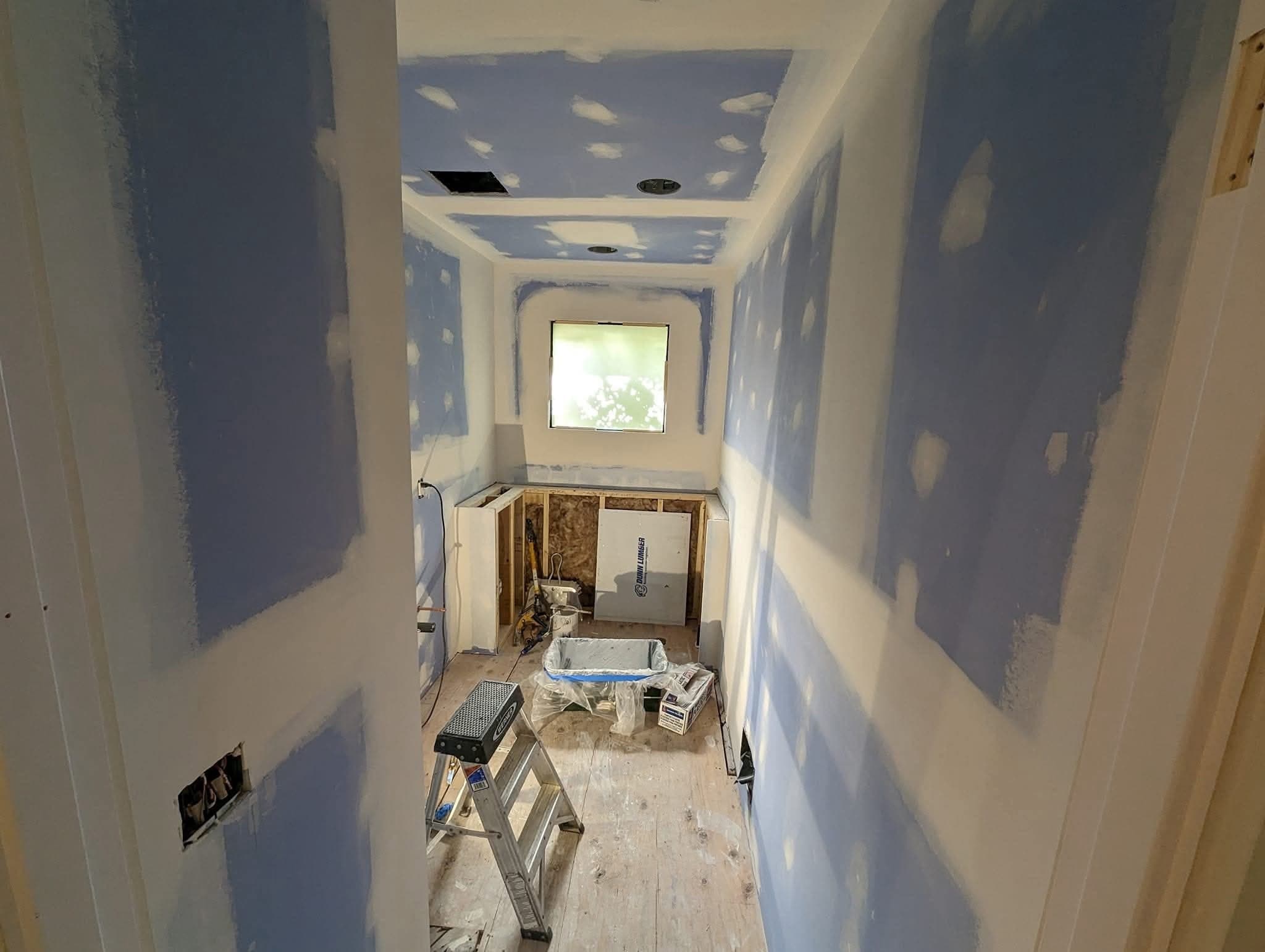 A room taped and mudded, with compound over every joint, corner and fastener head, ready for texture